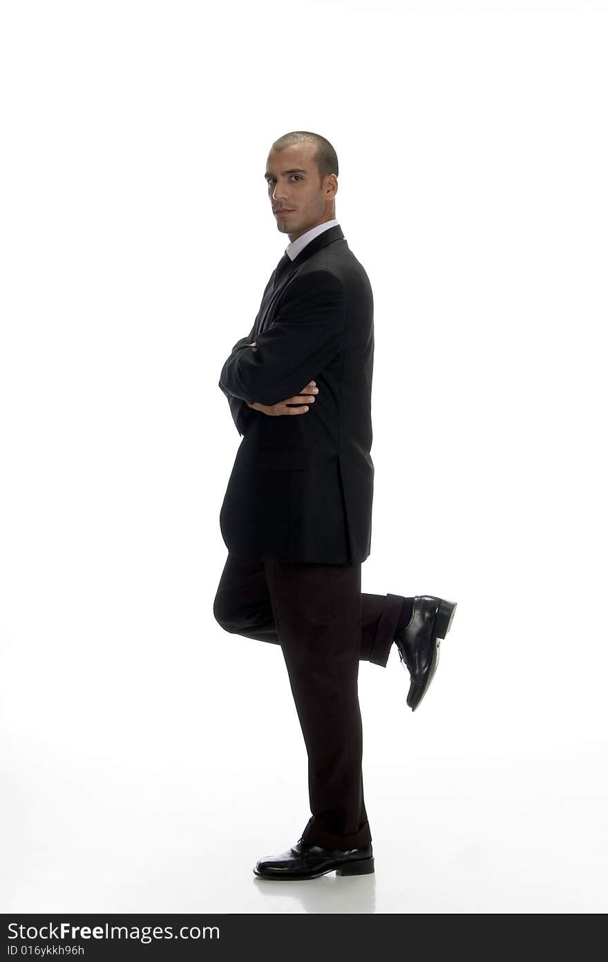 Young businessman standing on one leg with white background