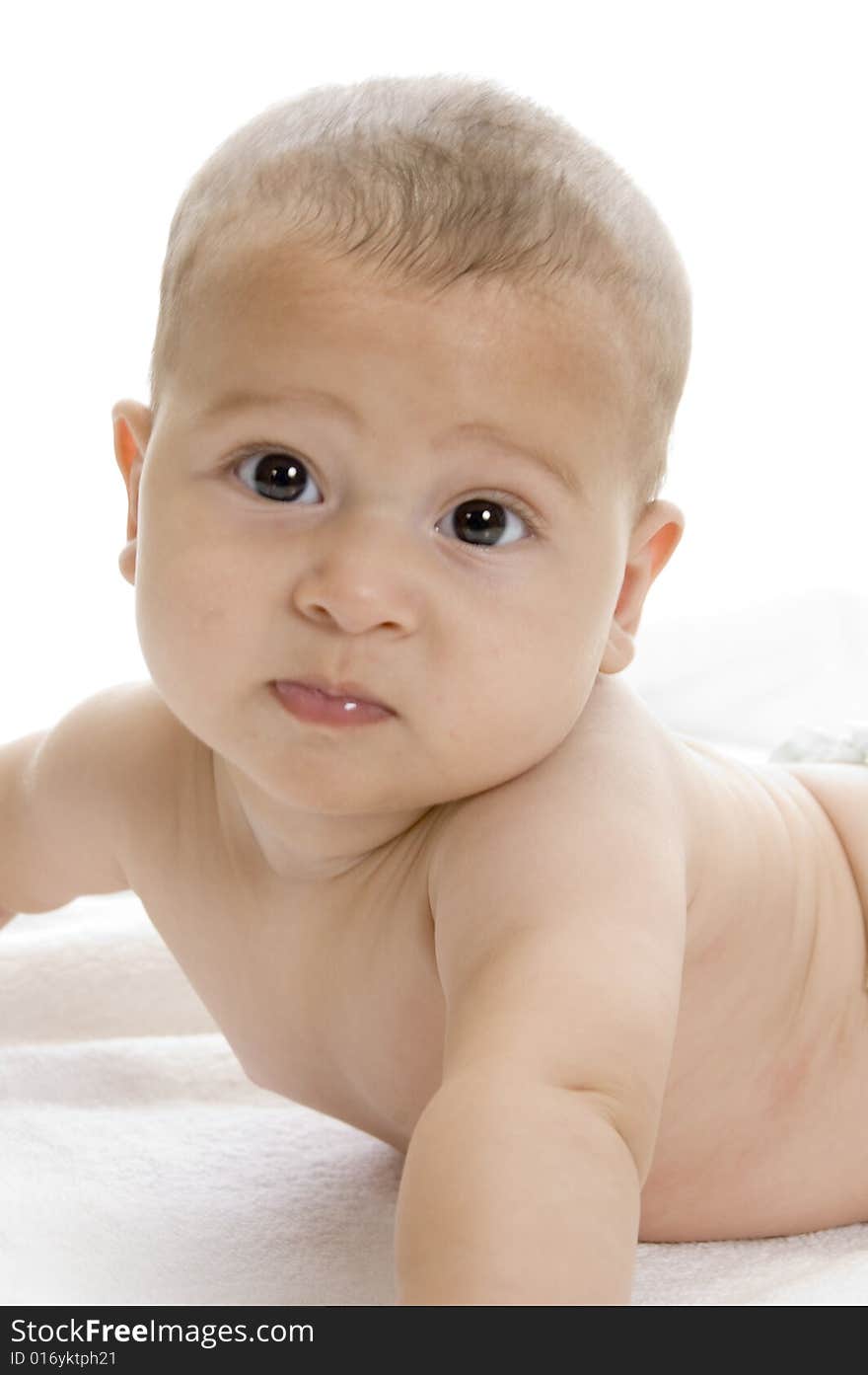 Happy child lying and looking at camera on an isolated white background