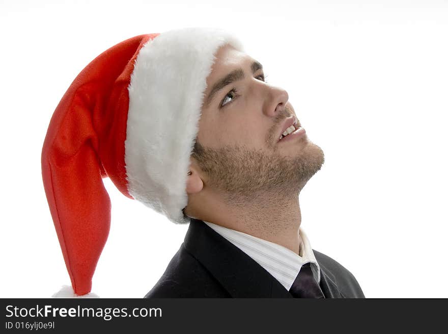 Young man looking upside and wearing santa cap