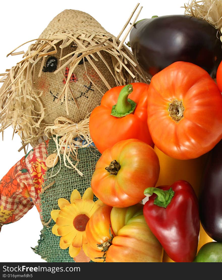 Scarecrow with vegetables on white isolated