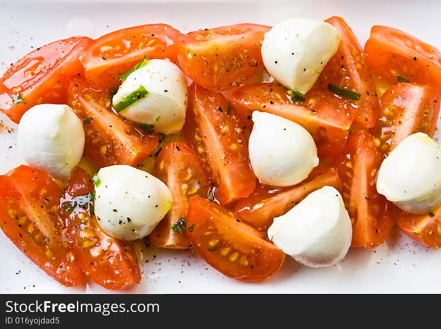 Tomato and mozzarella on a white plate