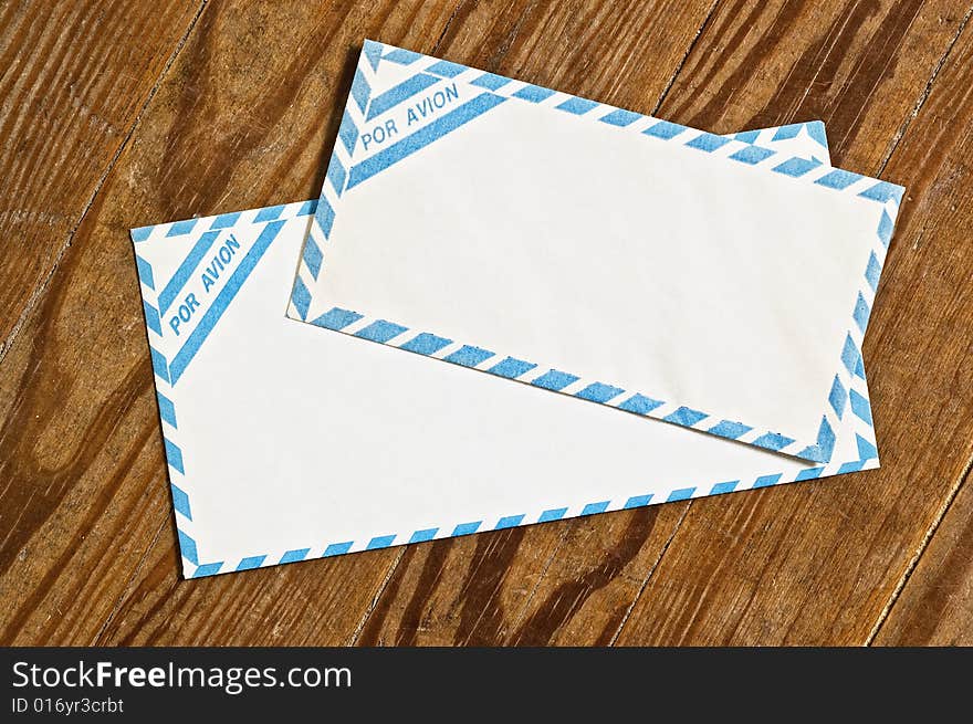 Old airmail envelopes over an old wooden table. Old airmail envelopes over an old wooden table.