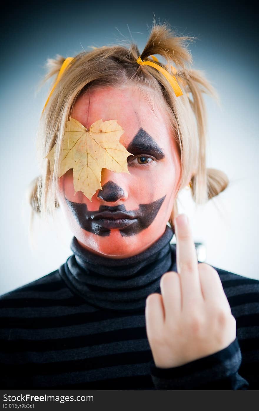 Upset Jack-o-lantern girl with leaf on face