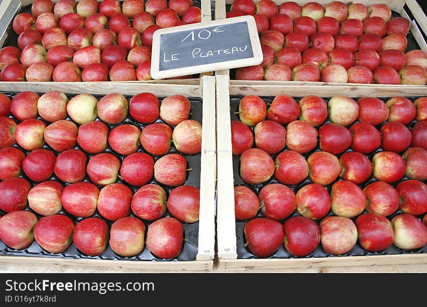 Rows of fresh red apples on display on French market