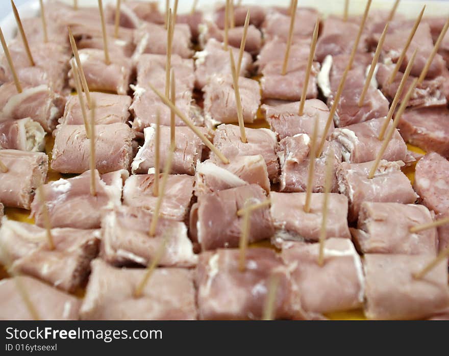 Sliced ham and tooth picks as finger food at party