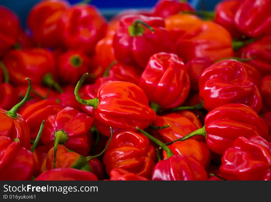 A box of red peppers on a food market. A box of red peppers on a food market.