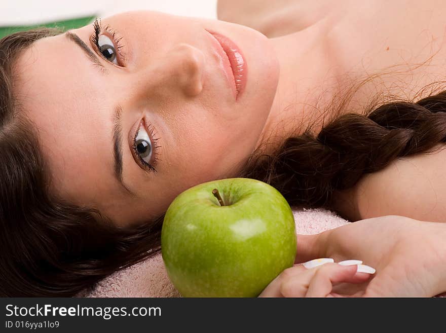 Beautiful young woman in towel holding green apple. Beautiful young woman in towel holding green apple