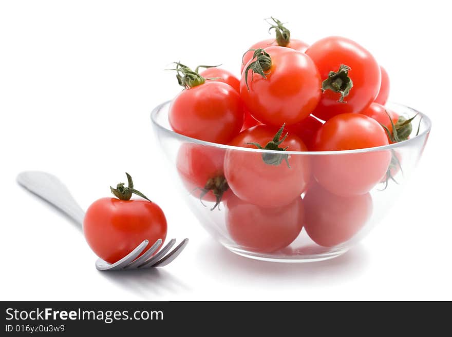 Ripe tomatoes cherry isolated in glass bowl. Ripe tomatoes cherry isolated in glass bowl