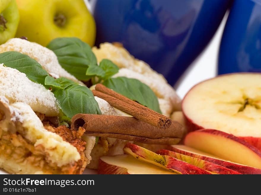 Apple pie on the plate with apples in the background