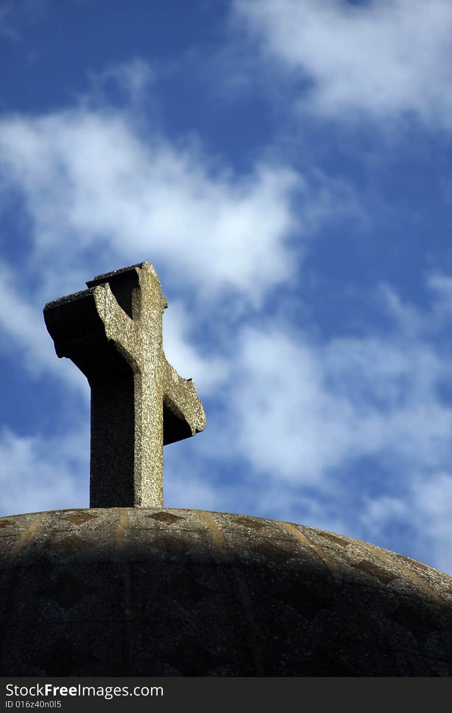 Stone cross low angle view against the sky.