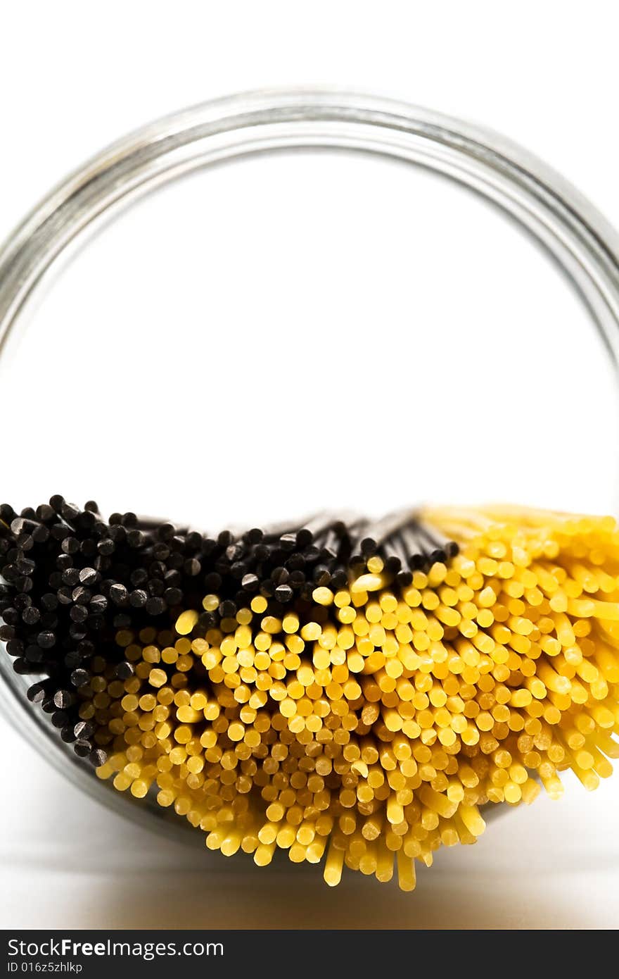 Yellow and black paste in glass can