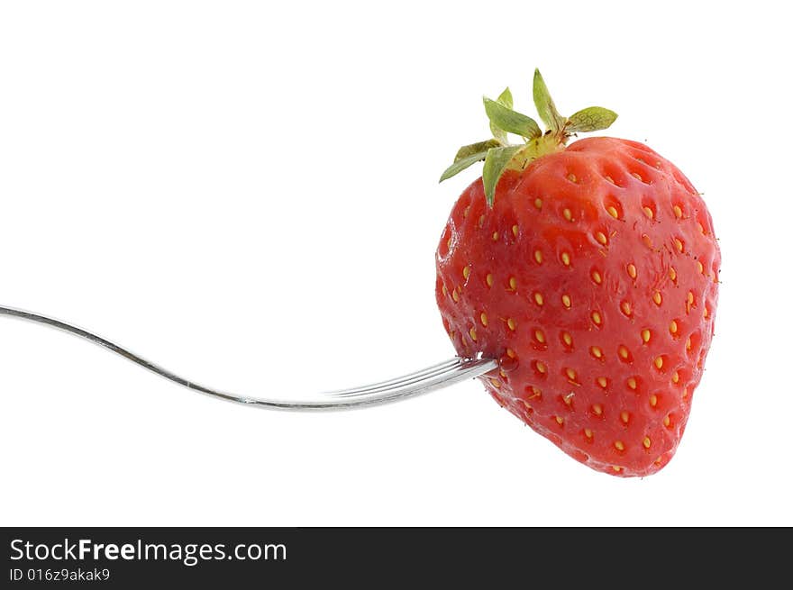 Close-up of a strawberry and fork isolated on a white background. Close-up of a strawberry and fork isolated on a white background