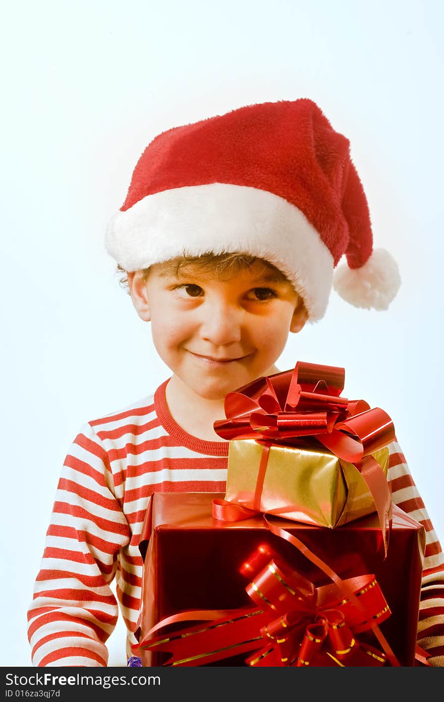 Young boy with Christmas hat and presents. Young boy with Christmas hat and presents