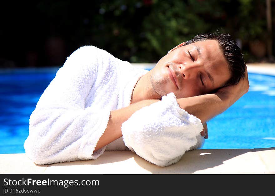 Friendly wellness spa man tanning on the pool. Friendly wellness spa man tanning on the pool