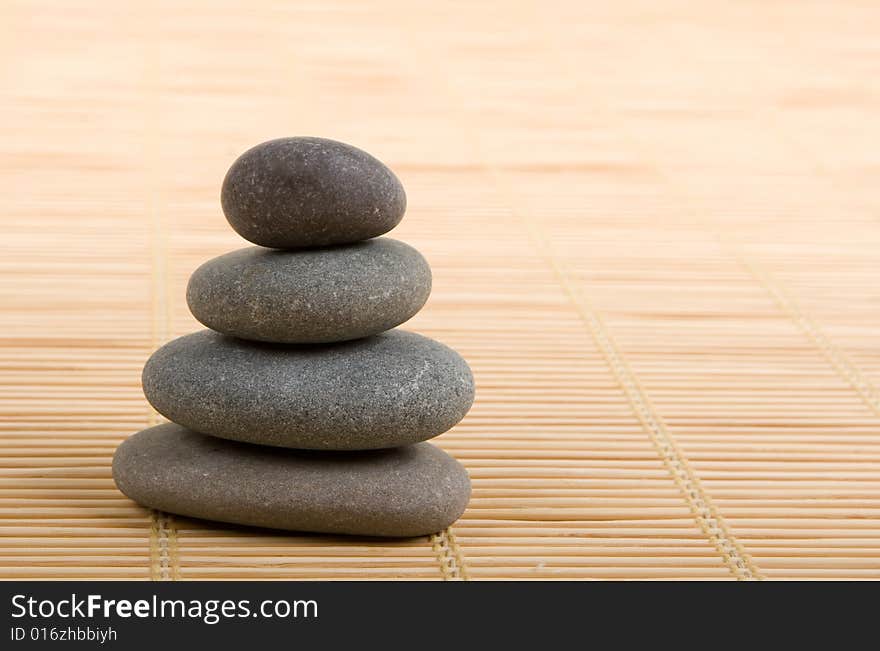 Balanced stones isolated on wooden background