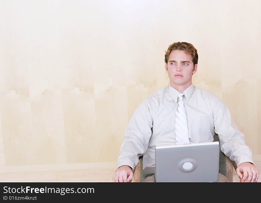 Businessman sitting with his laptop computer thinking. Businessman sitting with his laptop computer thinking.