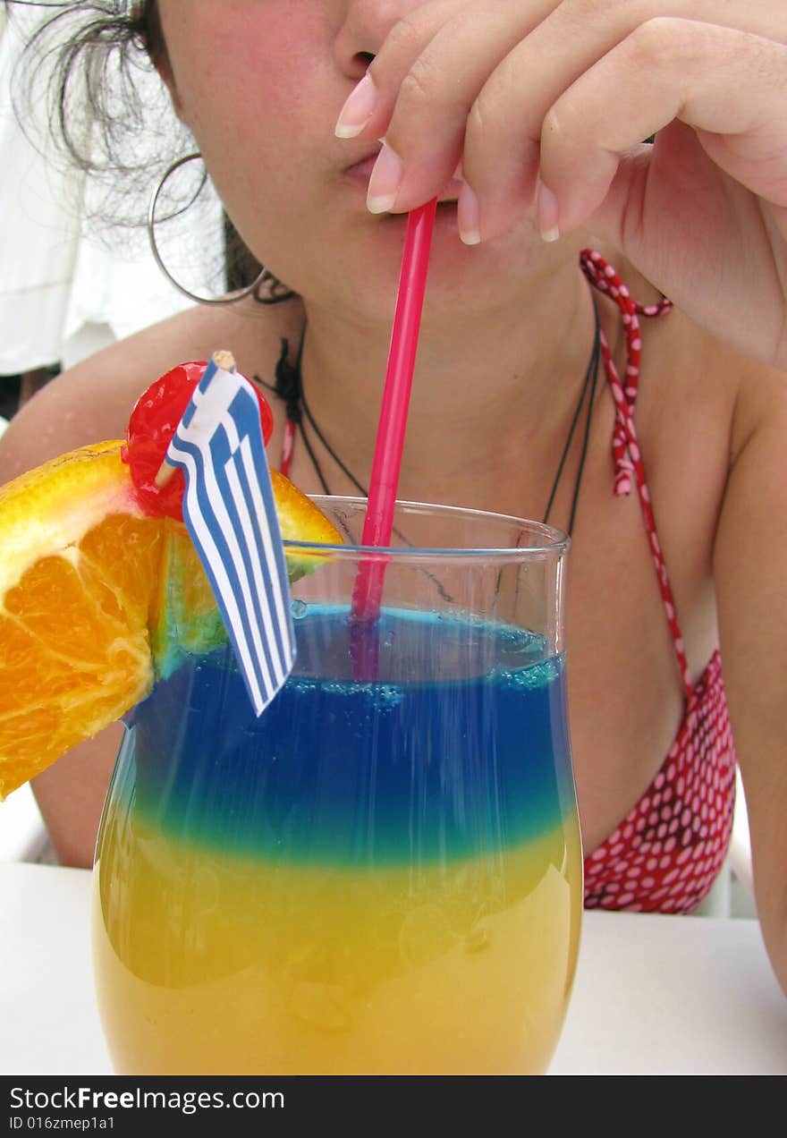 Young lady drinking tropical cocktail