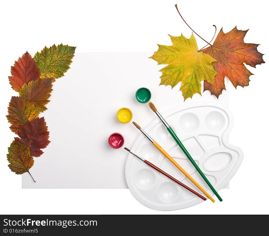 Paints, brushes and autumn leaves on a white background. We draw autumn.