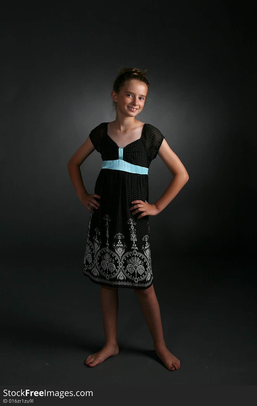 Friendly looking girl standing with black dress. Friendly looking girl standing with black dress