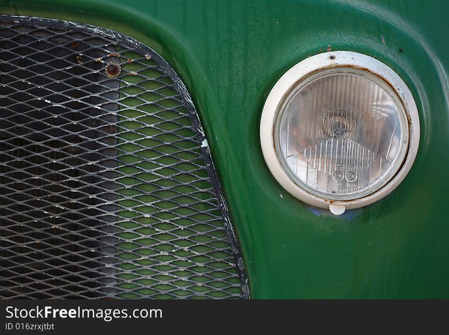 A close up photo of a green vintage car. A close up photo of a green vintage car