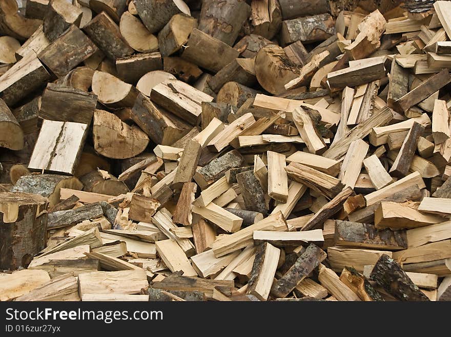 Stack of cleaved firewood getting prepared for winter. Stack of cleaved firewood getting prepared for winter.