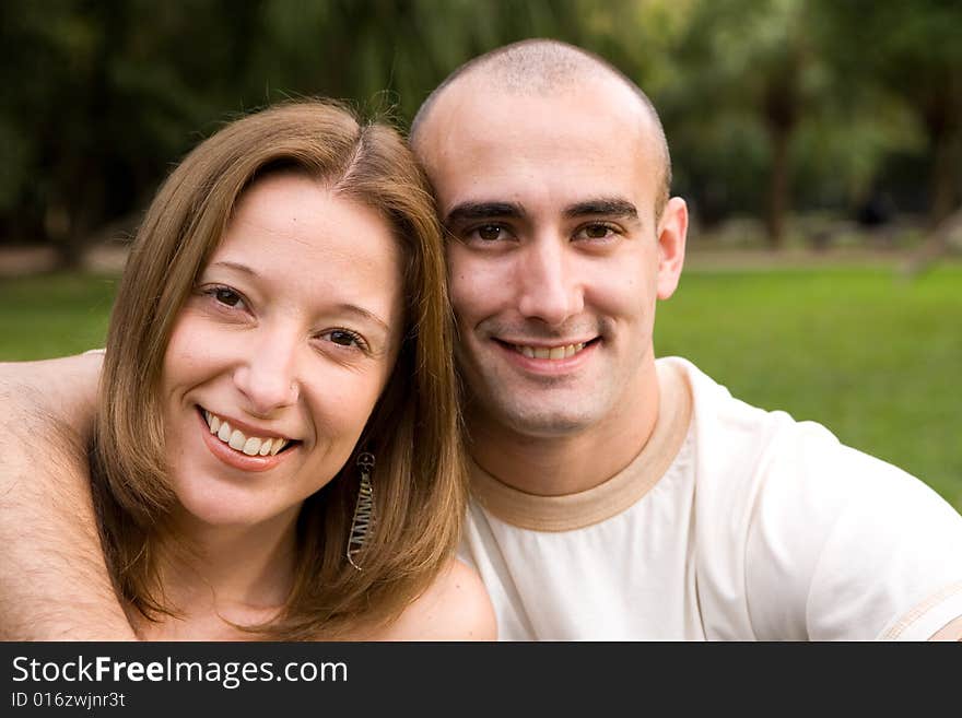 Beautiful young couple on the park in sunny day