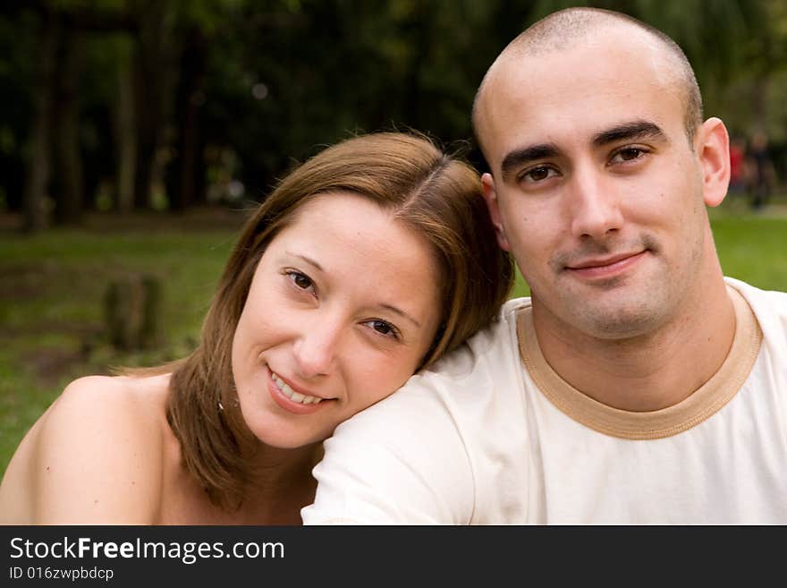 Beautiful young couple on the park in sunny day