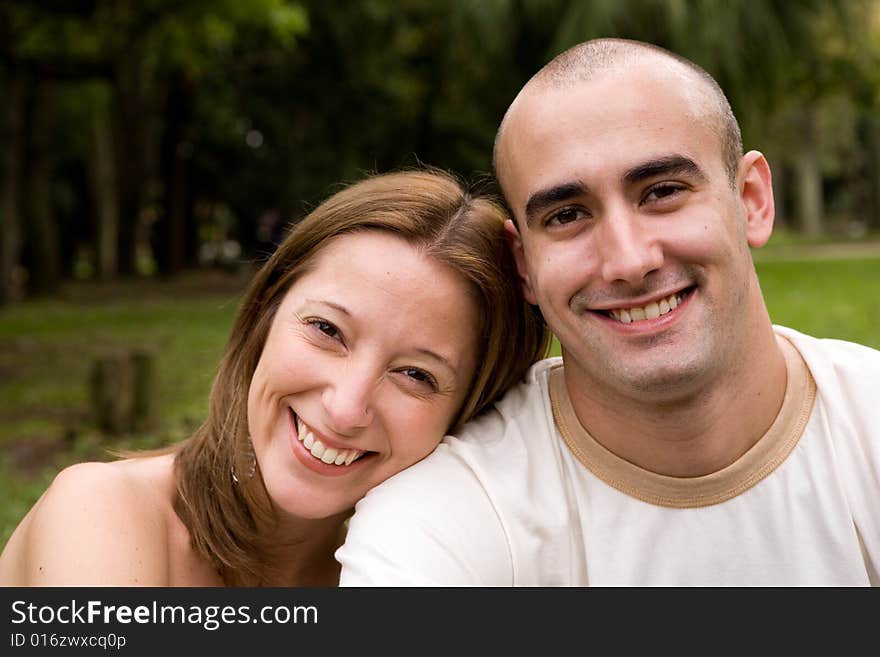 Beautiful young couple on the park in sunny day