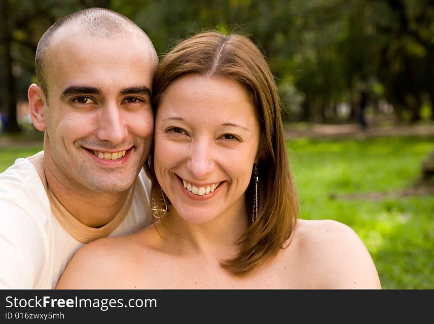 Beautiful young couple on the park in sunny day