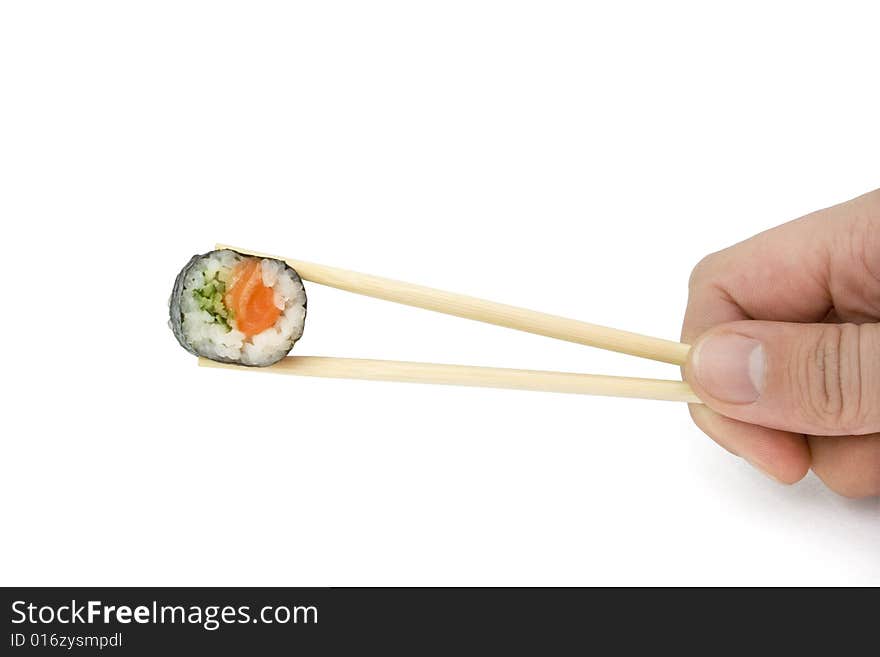 Hand hold one sushi roll with salmon and cucumber in chopsticks. this is isolated on the white background