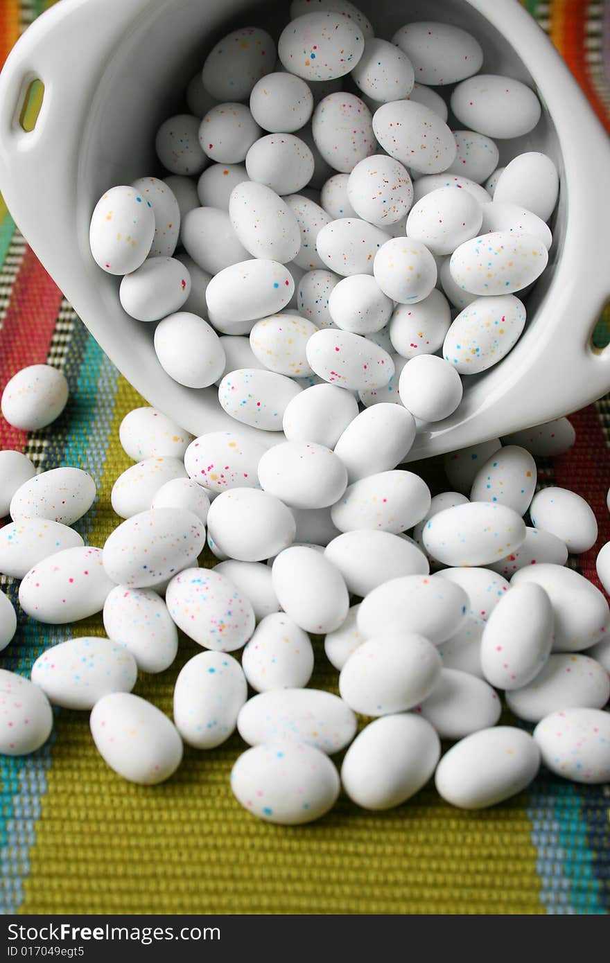 Miniature speckled easter eggs in a green bowl