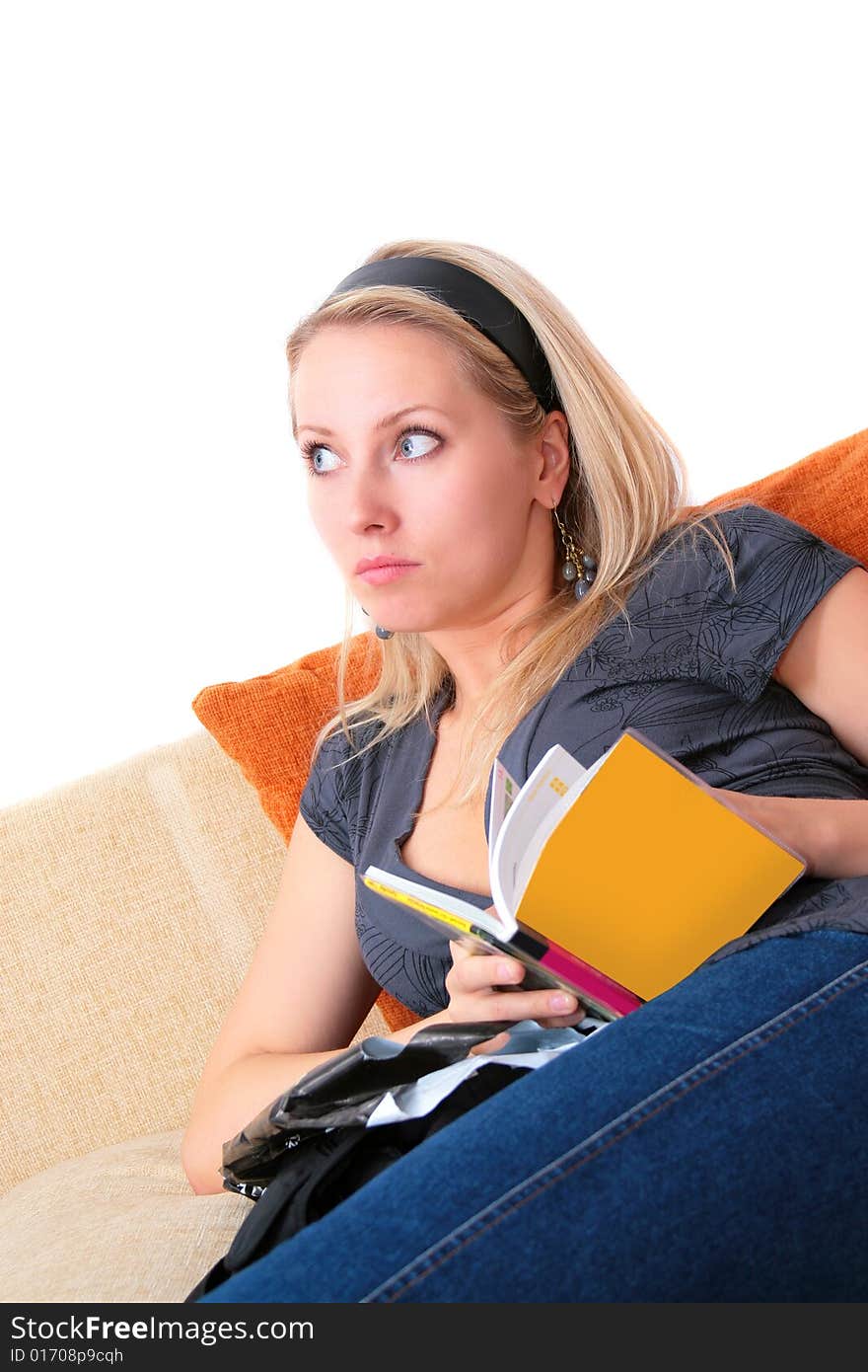 The girl with book on the sofa. The girl with book on the sofa