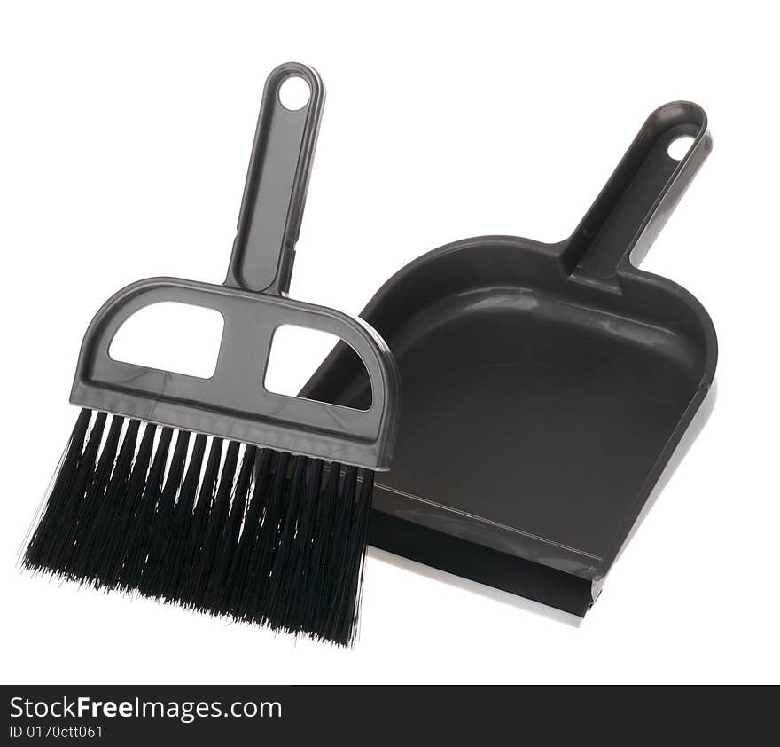 Brush and dustpan. The tool for cleaning it is isolated on a white background