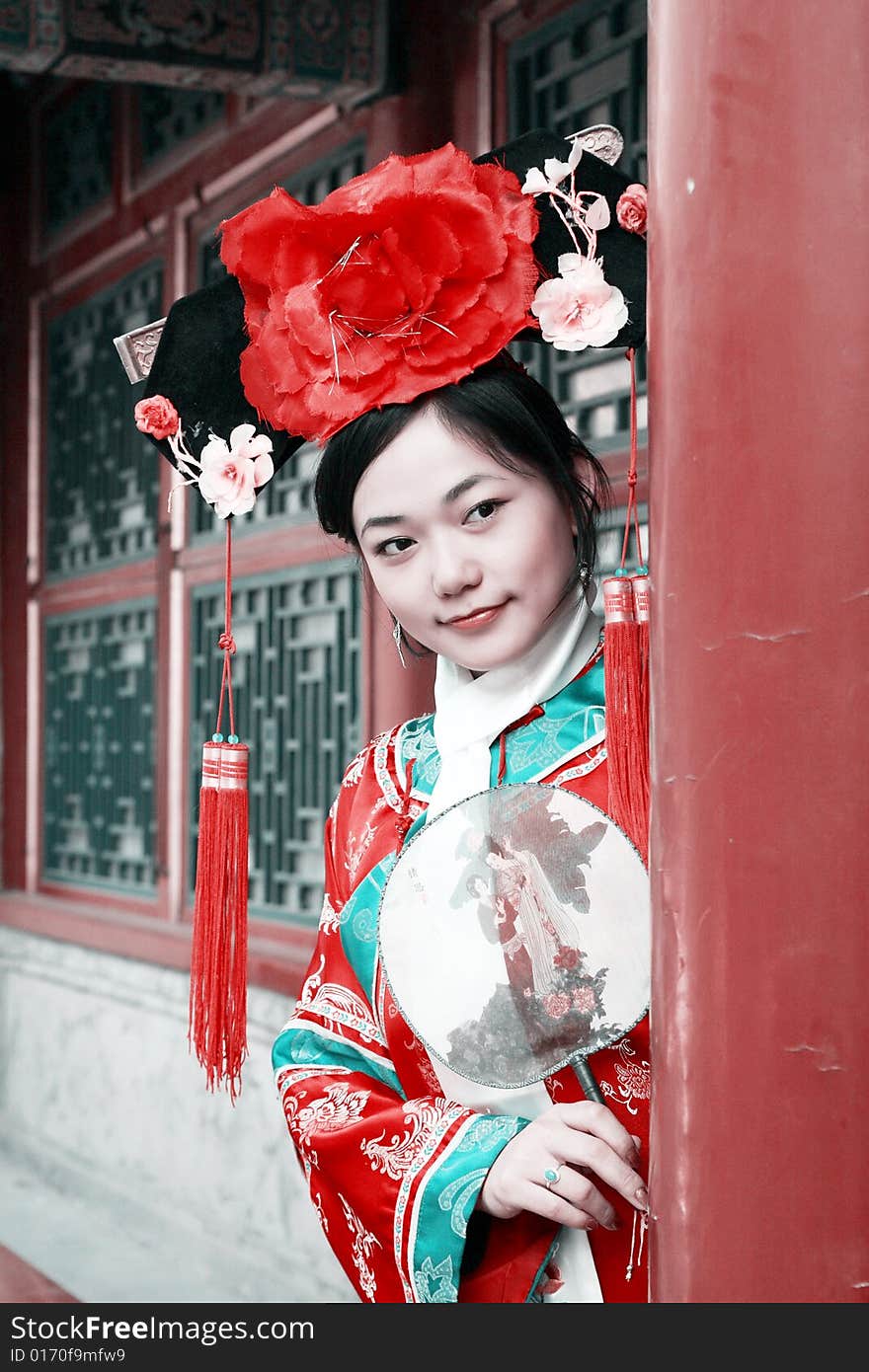 Portrait of a beautiful girl in Chinese ancient dress. 
Chinese on the fan is meant and missed. Portrait of a beautiful girl in Chinese ancient dress. 
Chinese on the fan is meant and missed.