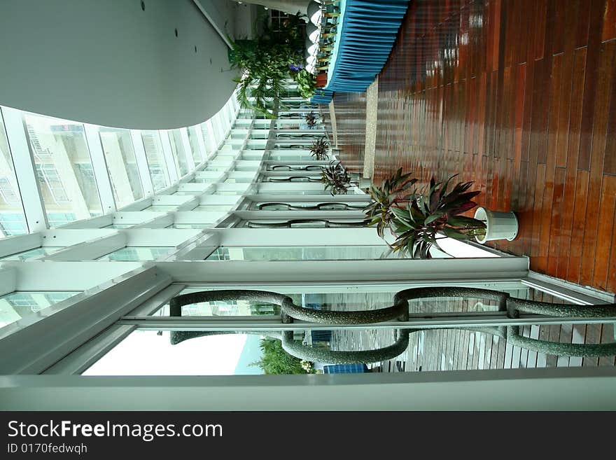 Spacious dinning hall corridor with wooden floor and glass roof