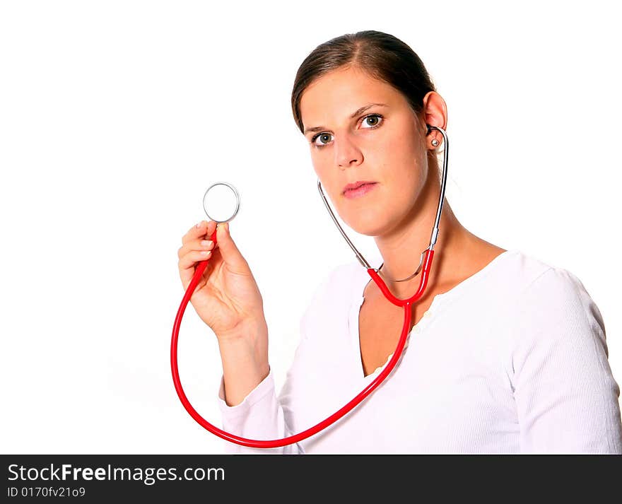 A young female doctor with a stethoscope around the neck ready for examination. Isolated over white. A young female doctor with a stethoscope around the neck ready for examination. Isolated over white.