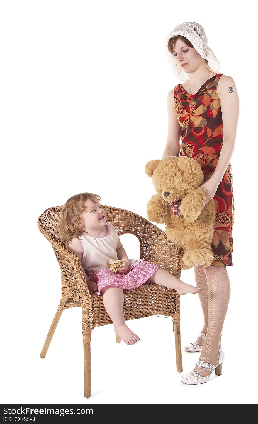 The young woman persuading the little girl to play with it in toys. It is isolated on the white