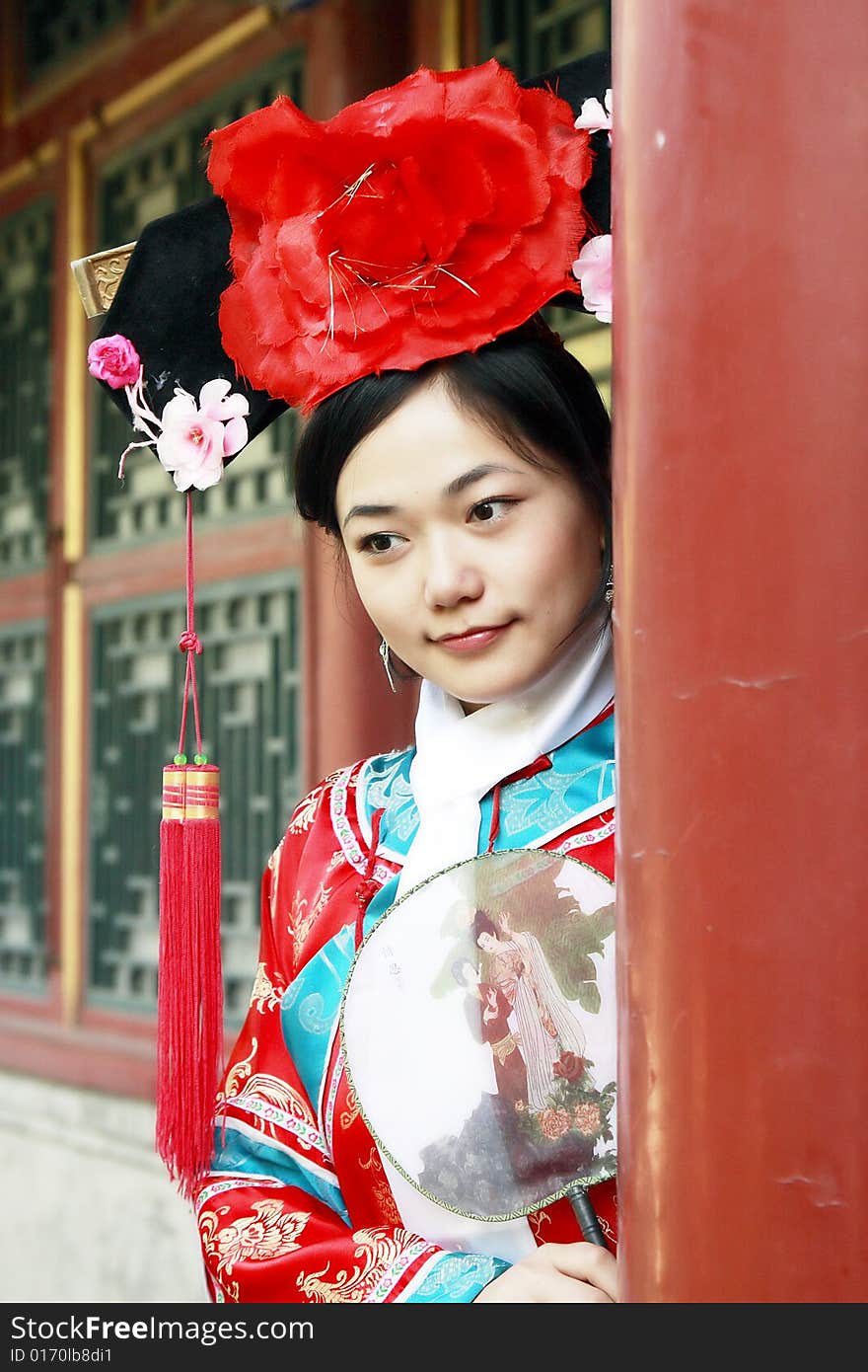 Portrait of a beautiful girl in Chinese ancient dress. 
Chinese on the fan is meant and missed. Portrait of a beautiful girl in Chinese ancient dress. 
Chinese on the fan is meant and missed.