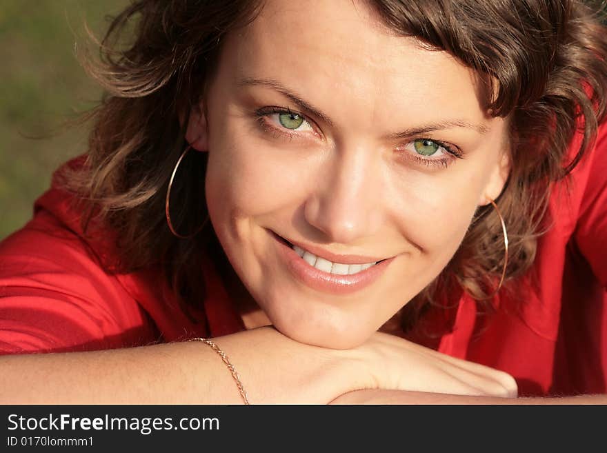 Portrait of a happy beautiful young woman with bright green eyes made outdoor. Portrait of a happy beautiful young woman with bright green eyes made outdoor