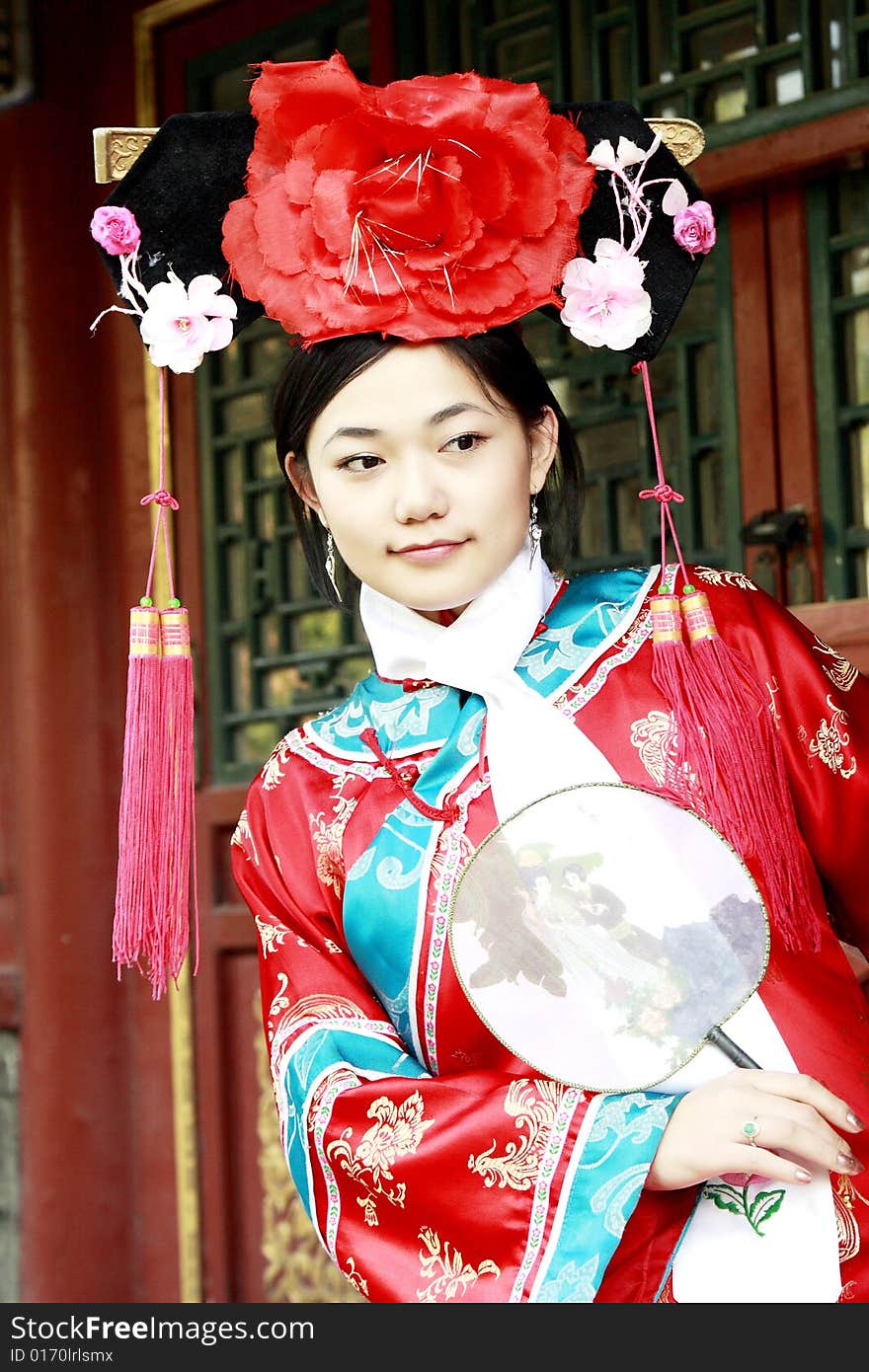 Portrait of a beautiful girl in Chinese ancient dress. 
Chinese on the fan is meant and missed. Portrait of a beautiful girl in Chinese ancient dress. 
Chinese on the fan is meant and missed.