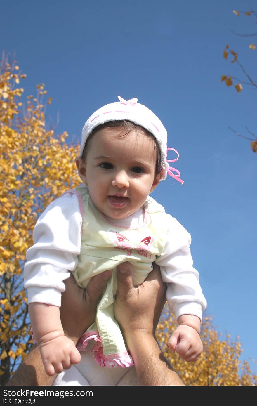 Baby on the sky background  on a sunny autumn day. Baby on the sky background  on a sunny autumn day