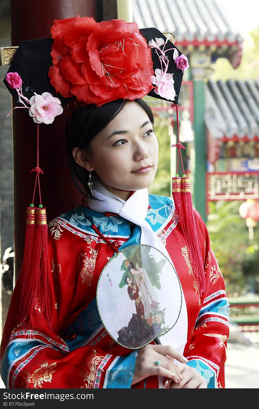 Portrait of a beautiful girl in Chinese ancient dress. 
Chinese on the fan is meant and missed. Portrait of a beautiful girl in Chinese ancient dress. 
Chinese on the fan is meant and missed.