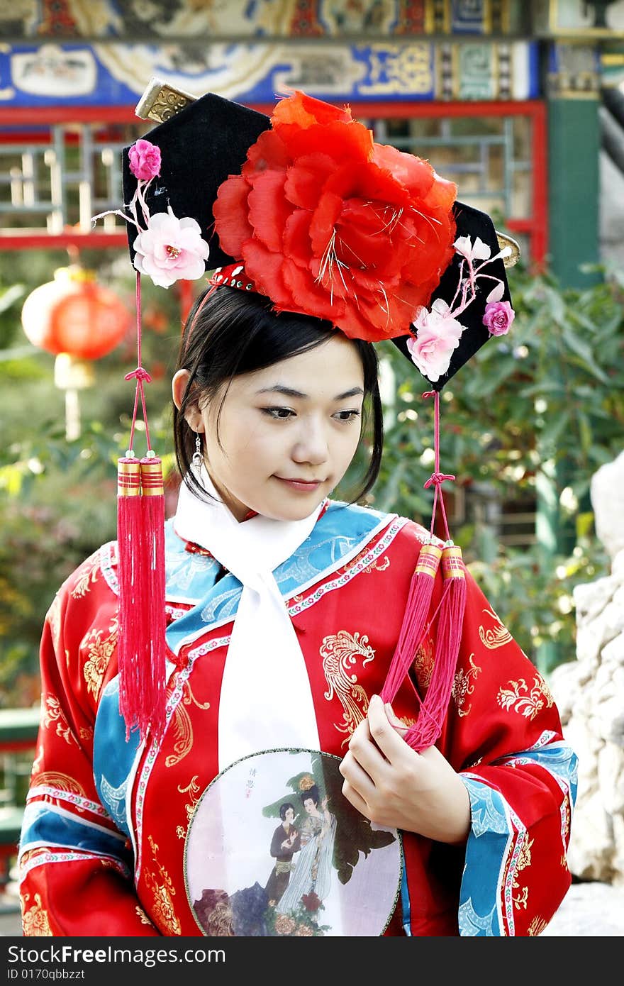 A beautiful girl in Chinese ancient dress is in the royal garden.

This is dress of Qing Dynasty of China. It is the princess' dress too.

Chinese on the fan is meant and missed. A beautiful girl in Chinese ancient dress is in the royal garden.

This is dress of Qing Dynasty of China. It is the princess' dress too.

Chinese on the fan is meant and missed.