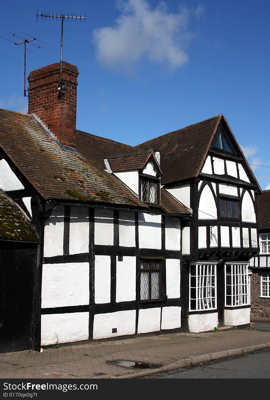 14th Century black and white half wood cottages, with flower baskets. 14th Century black and white half wood cottages, with flower baskets