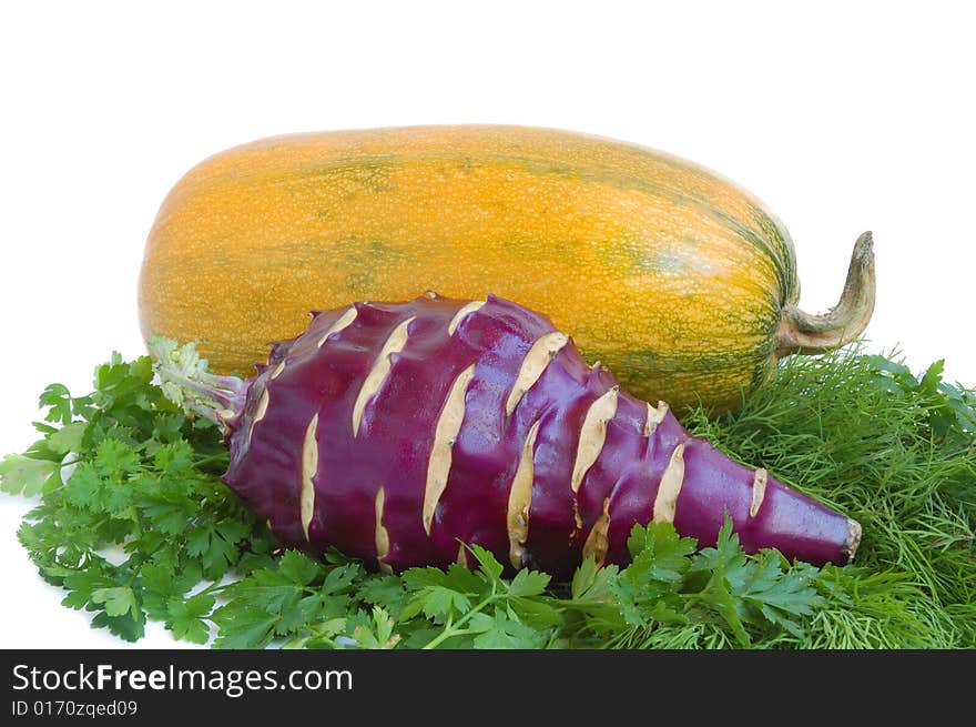 Yellow summer squash, kohlrabi and greens on white background