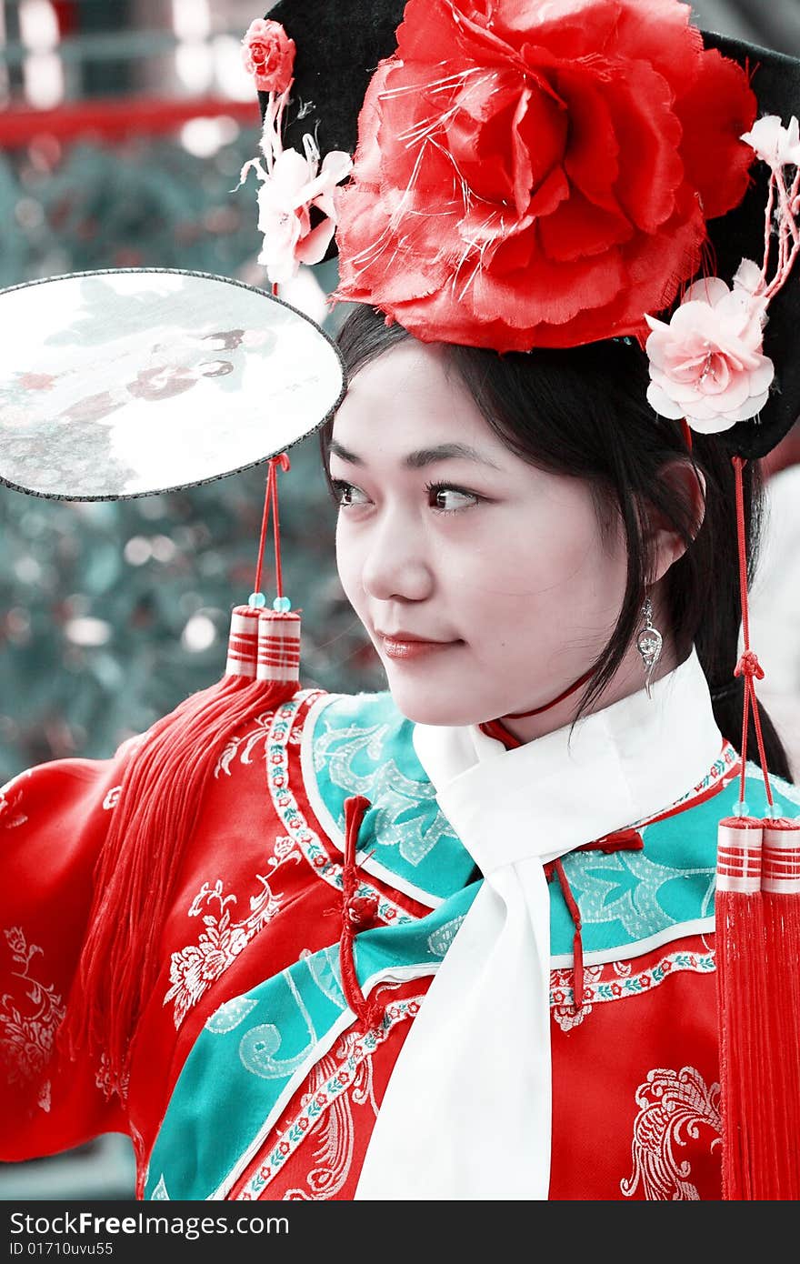 Portrait of a beautiful girl in Chinese ancient dress. 
Chinese on the fan is meant and missed. Portrait of a beautiful girl in Chinese ancient dress. 
Chinese on the fan is meant and missed.