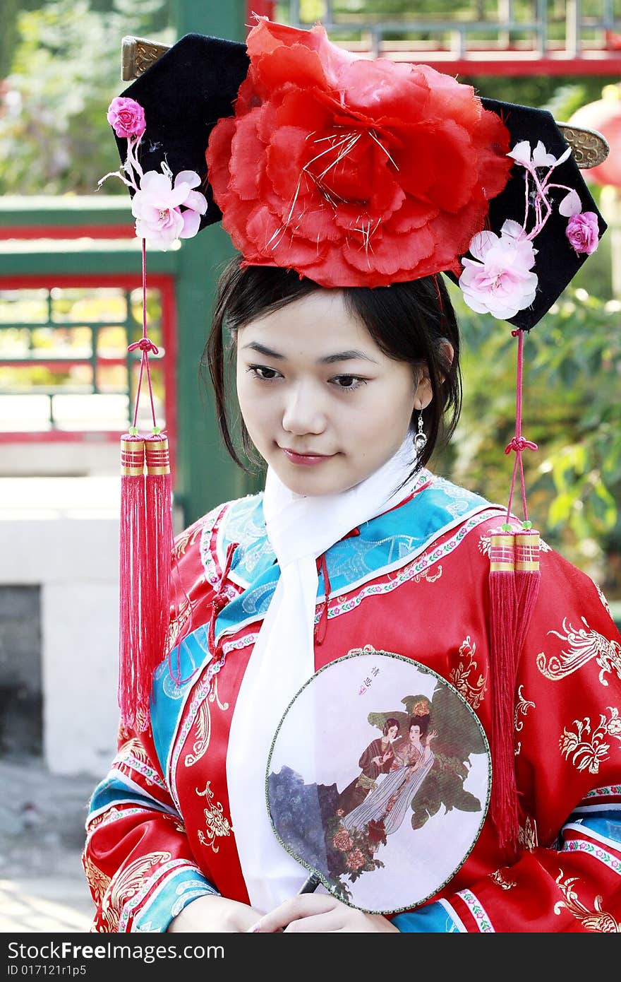 Portrait of a beautiful girl in Chinese ancient dress. 
Chinese on the fan is meant and missed. Portrait of a beautiful girl in Chinese ancient dress. 
Chinese on the fan is meant and missed.