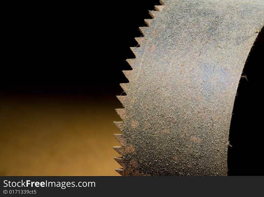 A rusty old curved saw covered in dust. A rusty old curved saw covered in dust