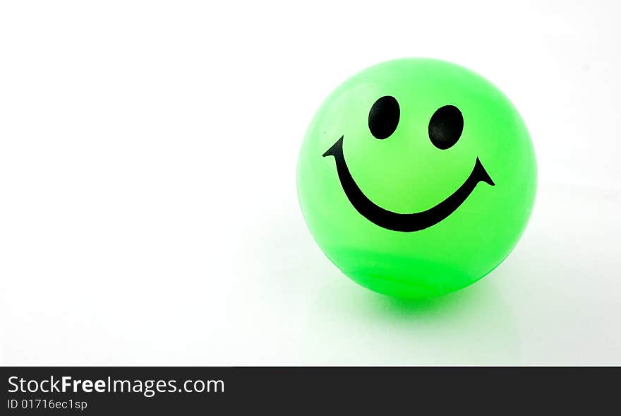 Green smiley ball on white background with copy space