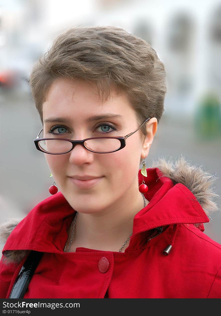 Portrait of a beautiful girl in red coat